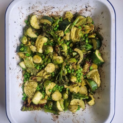 baking tray of roasted green vegetables with pesto