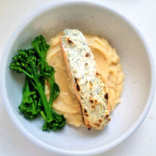 flat lay picture baked herby salmon on celeriac mash