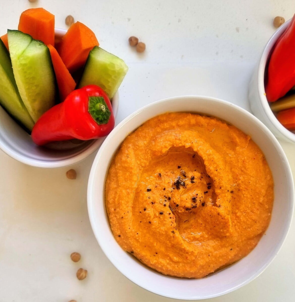 bowl of pepper hummus and raw vegetables