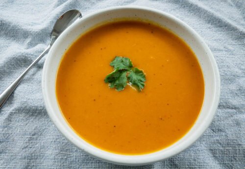 bowl of cajun spiced squash soup and spoon
