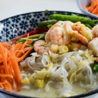 thai noodle soup with prawns in a bowl