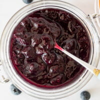 Easy sugar free jam for diabetics in a jar with blueberries in the background