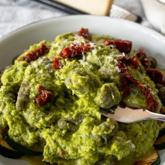 Green pesto gnocchi on a fork