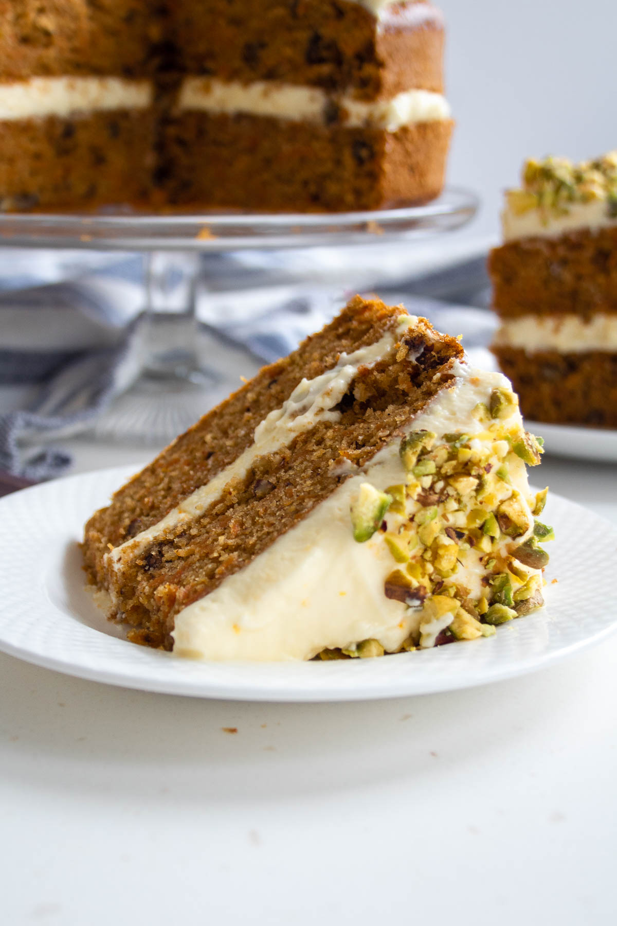 a slice of sugar free carrot cake lying on its side on a plate.