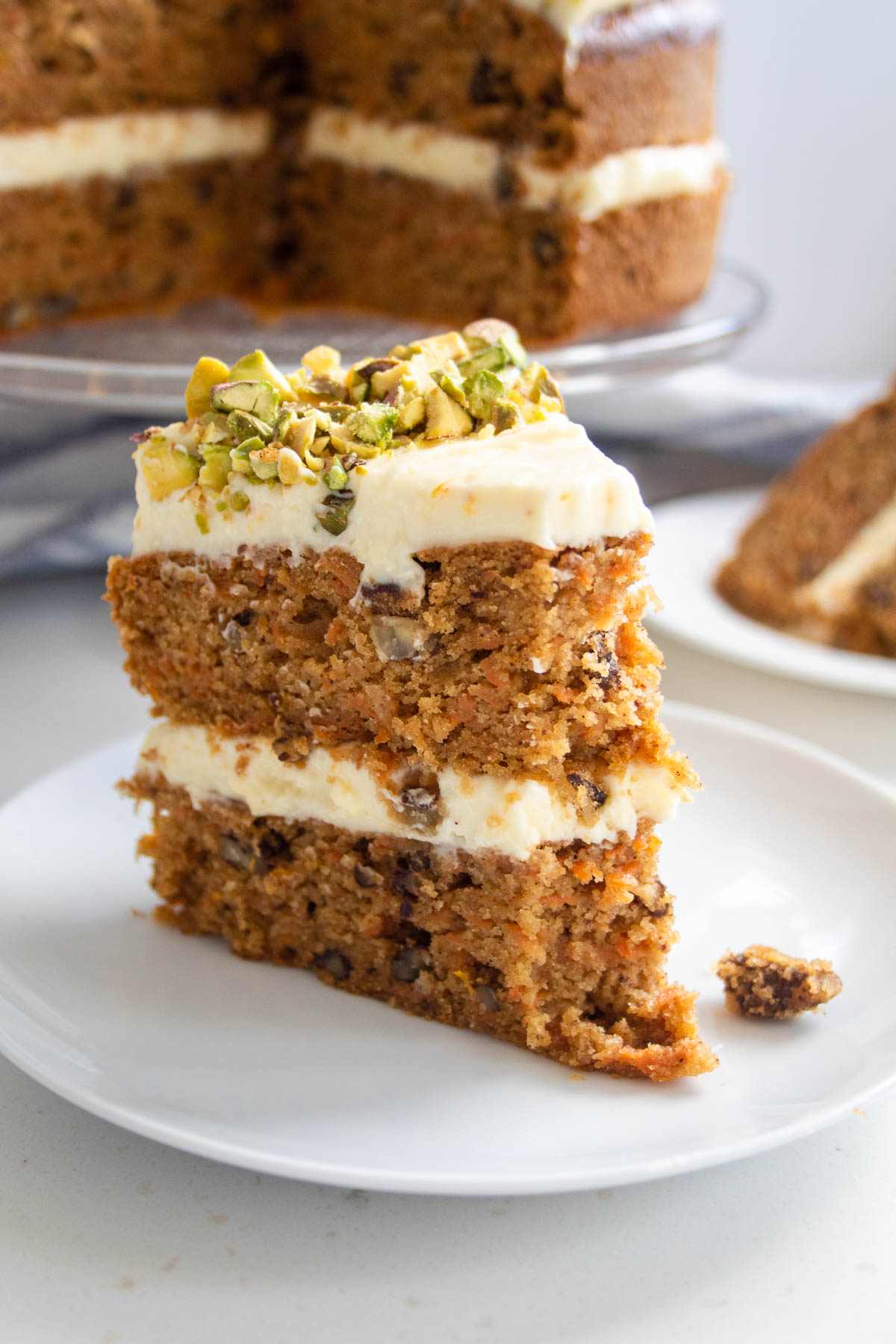 a slice of sugar free carrot cake with a piece taken from the front.