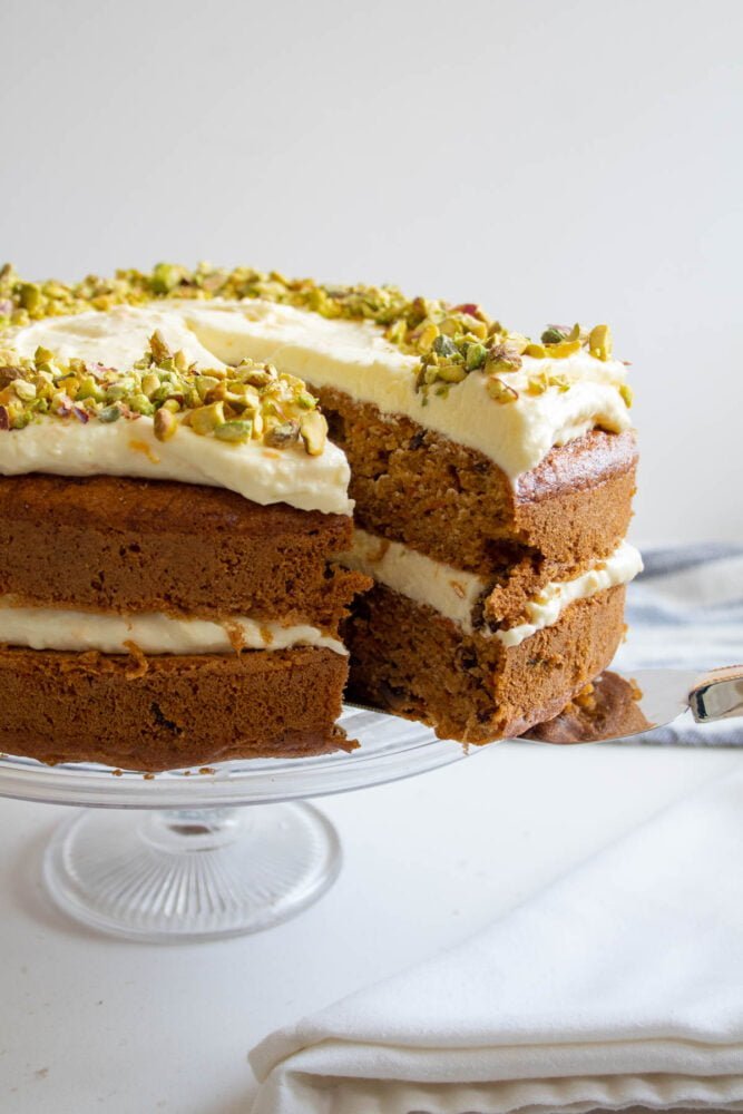 side view of a slice of sugar free carrot cake resting on a cake slice.