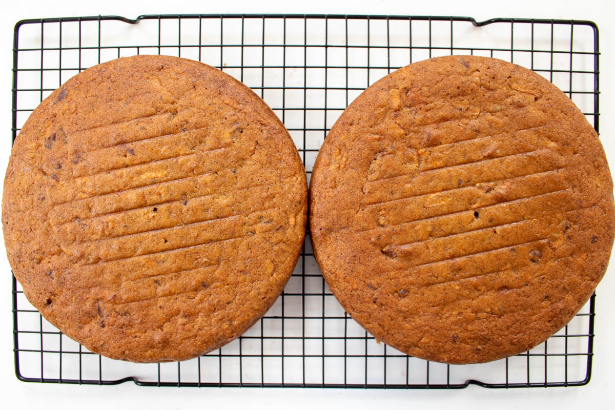 2 cooked carrot cake sponges on a cooling rack