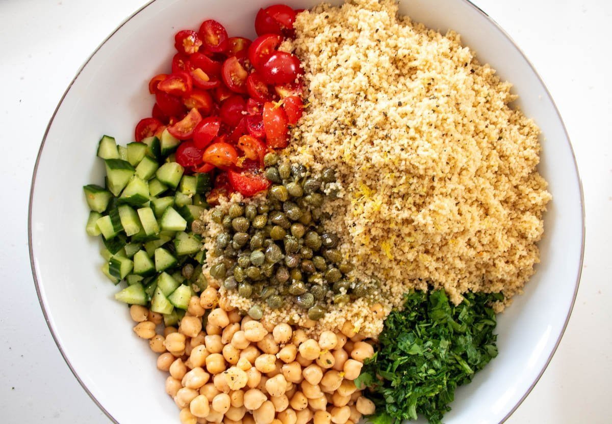 unmixed bowl of lemon chickpea couscous with all the ingredients in sections