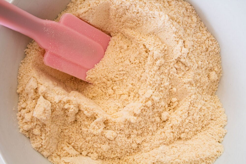 dry ingredients in a bowl with a pink spatula