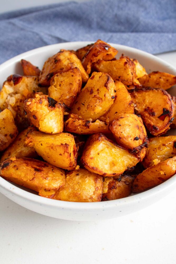 harissa roasted potatoes piled up in a bowl