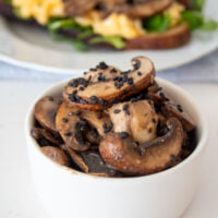 closeup of a bowl of miso glazed mushrooms