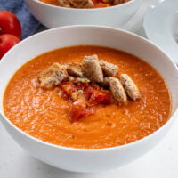 bowl of tomato and pesto soup with sundried tomatoes and croutons