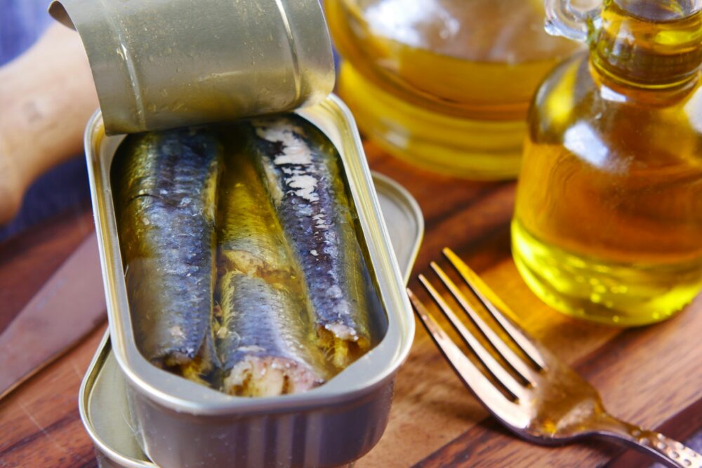 sardines in a tin and a bottle of olive oil for healthy fats