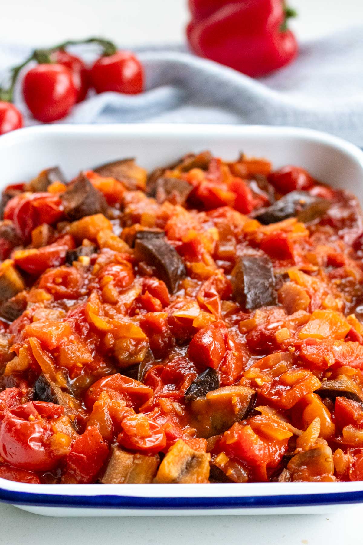 roasted veg sauce with tomatoes in a roasting pan
