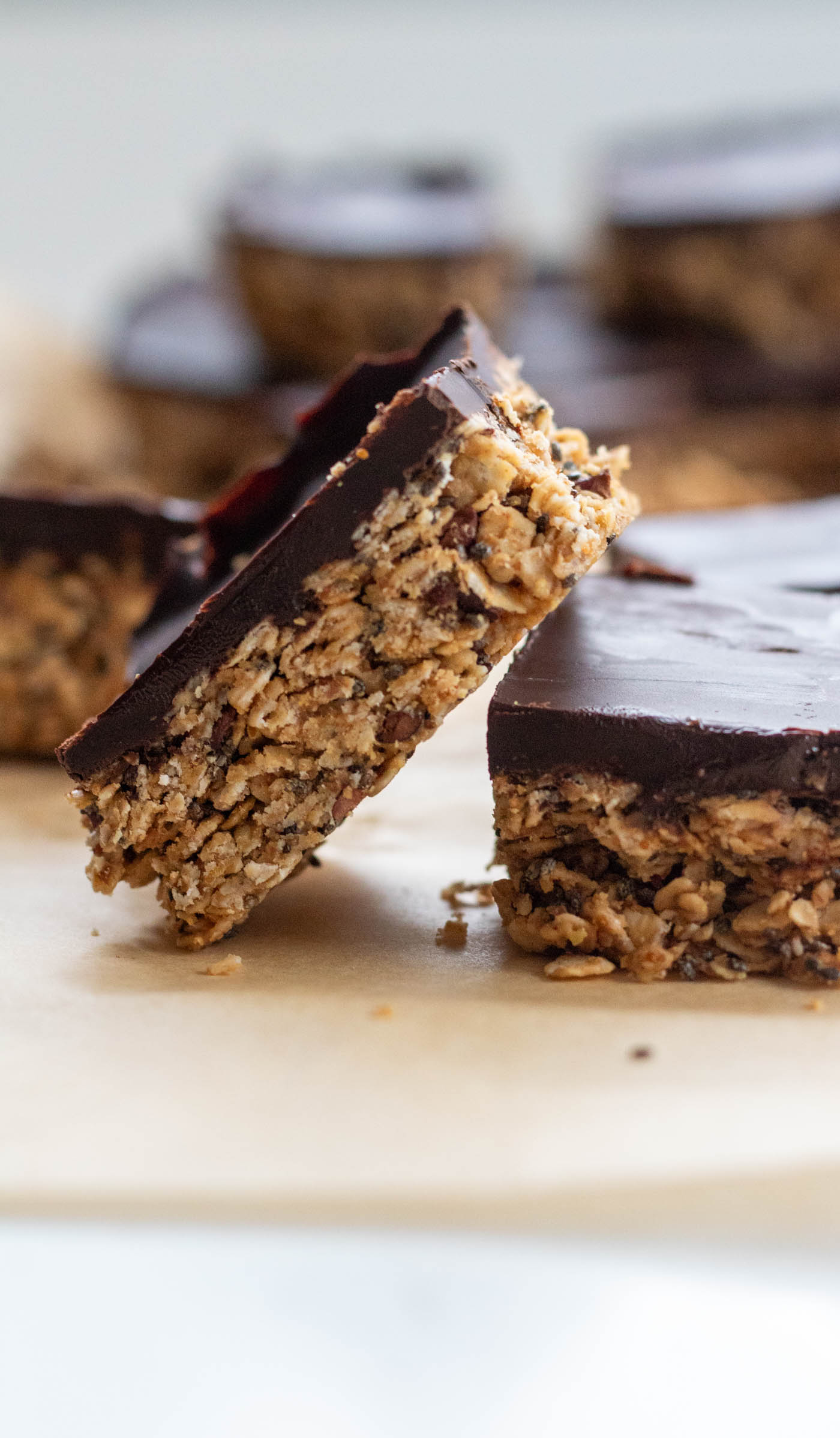 a no bake chocolate oat bars leaning on another oat bar