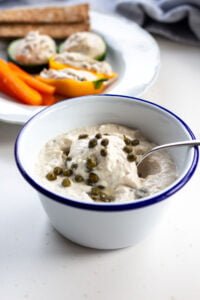 smoked mackerel dip with capers in a bowl with a spoon