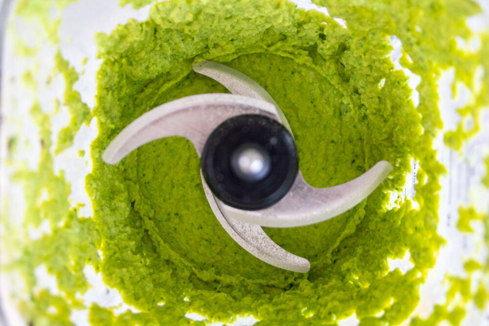 mixed green pea hummus looking down into the food processor