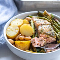 Easy Salmon, Broccoli & Potatoes with Asparagus in a dish with some salmon fillet on a fork