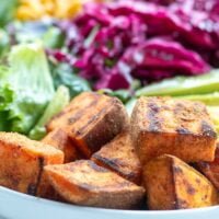 closeup of cubed sauteed sweet potatoes in a salad bowl