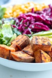 closeup of cubed sauteed sweet potatoes in a salad bowl