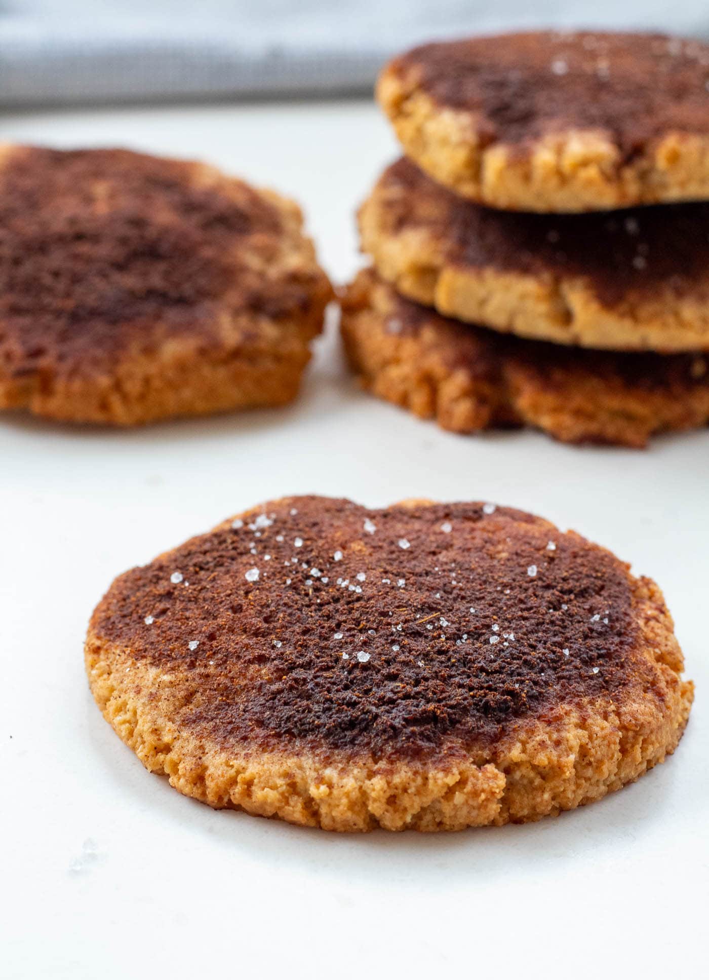 Close-up of sugar-free cinnamon cookies showing their golden-brown texture and cinnamon coating.