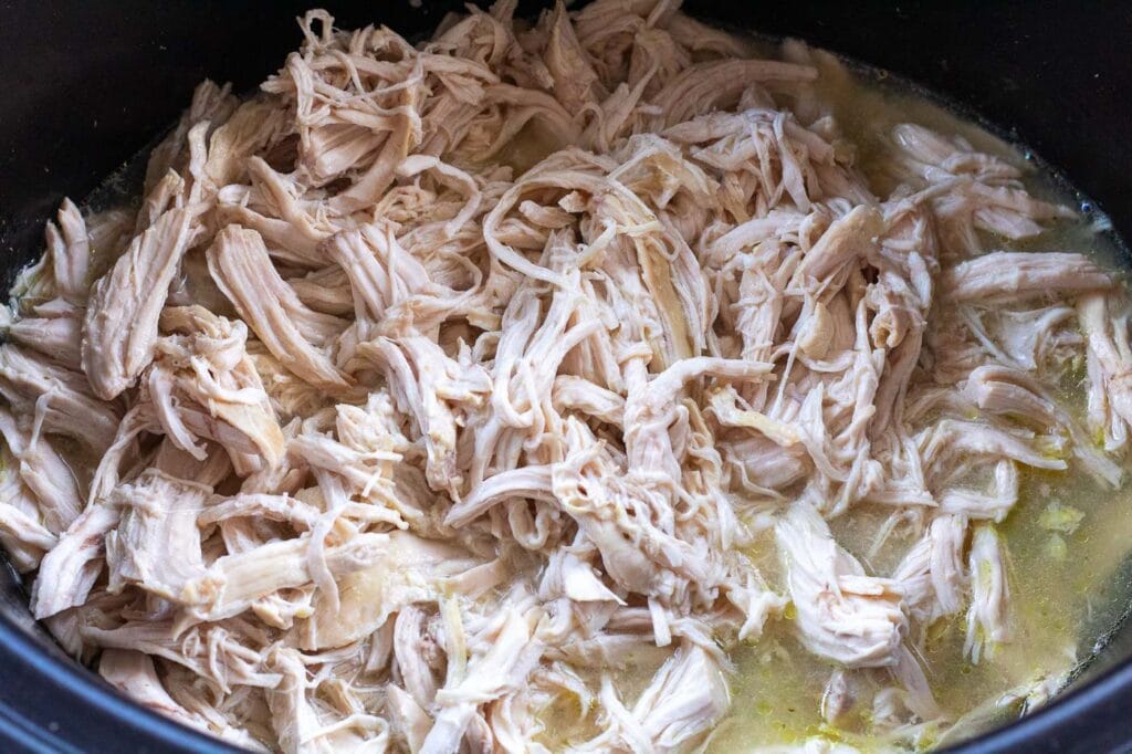 Shredded chicken stirred back into the cooking juices to stay moist and full of flavour.