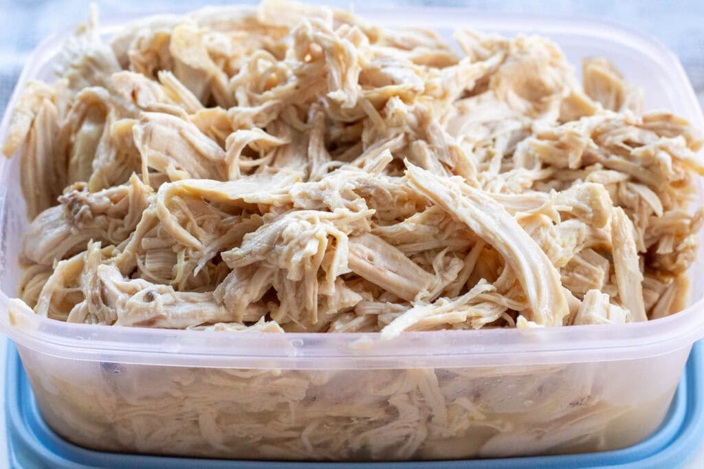 Meal-prep shredded chicken stored in an airtight container for quick, balanced lunches throughout the week