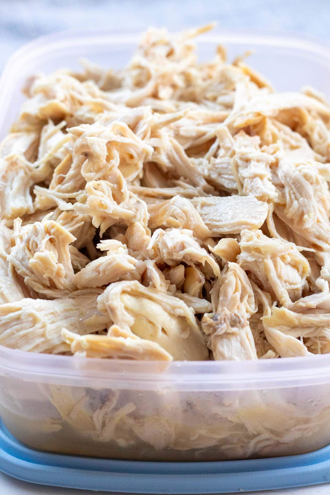 Meal-prep shredded chicken stored in an airtight container for quick, balanced lunches throughout the week