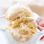 Close up of homemade Greek yogurt ice cream with vanilla bean paste in a glass serving dish.